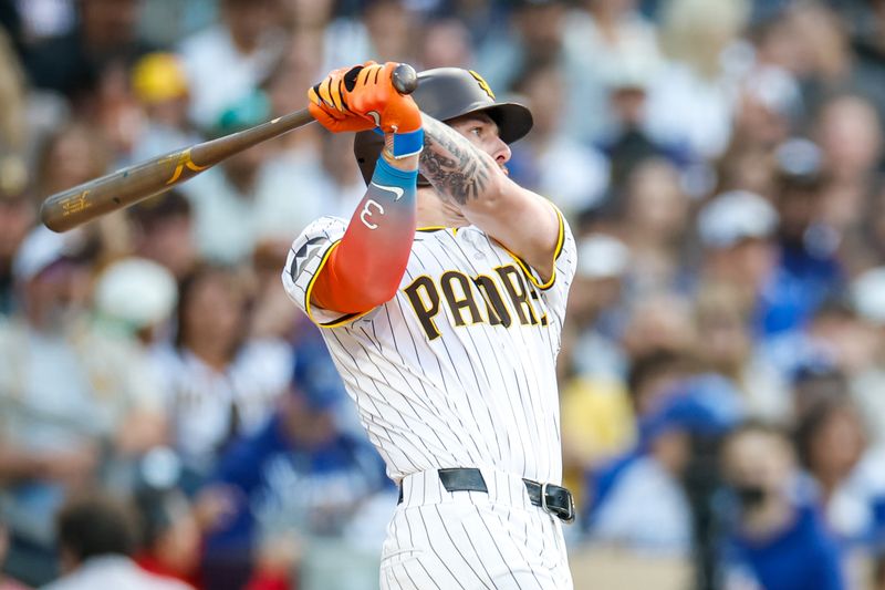 Jun 9, 2025; San Diego, California, USA; San Diego Padres center fielder Jackson Merrill (3) hits a sacrifice fly during the first inning against the Los Angeles Dodgers at Petco Park. Mandatory Credit: David Frerker-Imagn Images