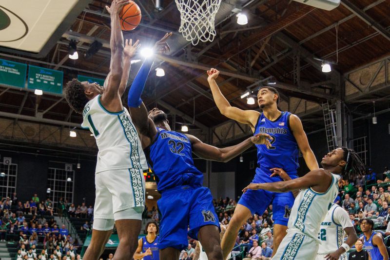 Jan 30, 2025; New Orleans, Louisiana, USA;  Tulane Green Wave forward Kaleb Banks (1) secures a rebound against Memphis Tigers center Moussa Cisse (32) during the first half at Avron B. Fogelman Arena in Devlin Fieldhouse. Mandatory Credit: Stephen Lew-Imagn Images