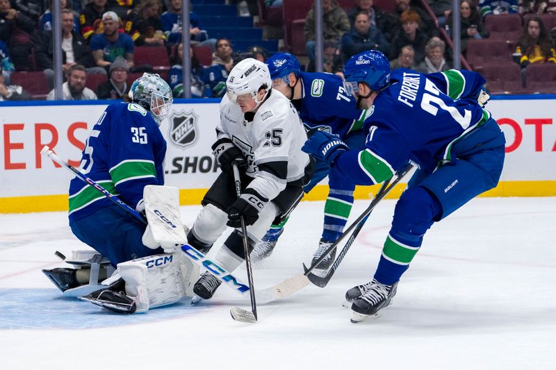 Jan 16, 2025; Vancouver, British Columbia, CAN; Vancouver Canucks defenseman Vincent Desharnais (73) and defenseman Derek Forbort (27) watch as goalie Thatcher Demko (35) makes a save on Los Angeles Kings forward Alex Turcotte (15) in the third period at Rogers Arena. Mandatory Credit: Bob Frid-Imagn Images