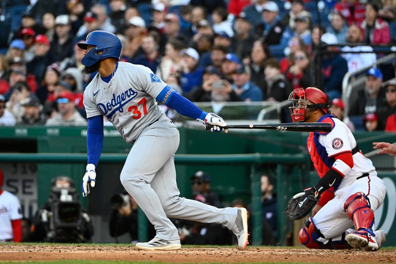 Apr 9, 2025; Washington, District of Columbia, USA; Los Angeles Dodgers outfielder Teoscar Hernández (37) hits a RBI single against the Washington Nationals during the seventh inning at Nationals Park. Mandatory Credit: Brad Mills-Imagn Images
