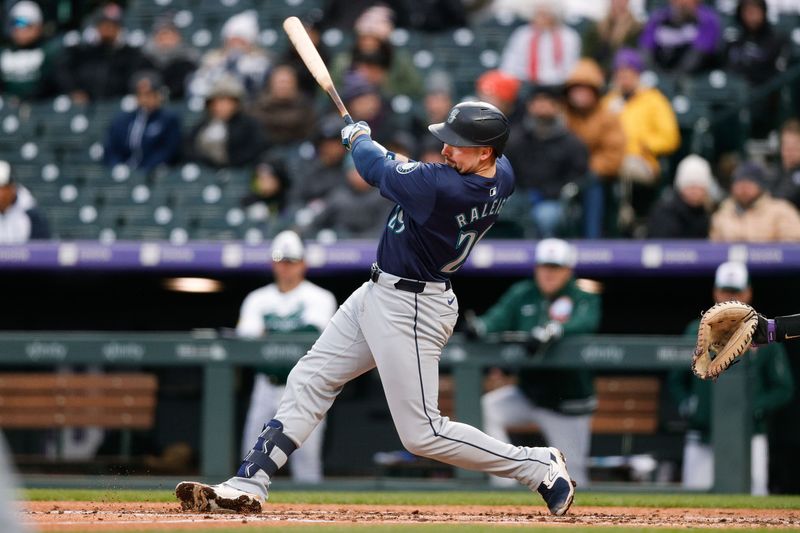 Apr 20, 2024; Denver, Colorado, USA; Seattle Mariners catcher Cal Raleigh (29) hits and RBI single in the third inning against the Colorado Rockies at Coors Field. Mandatory Credit: Isaiah J. Downing-USA TODAY Sports