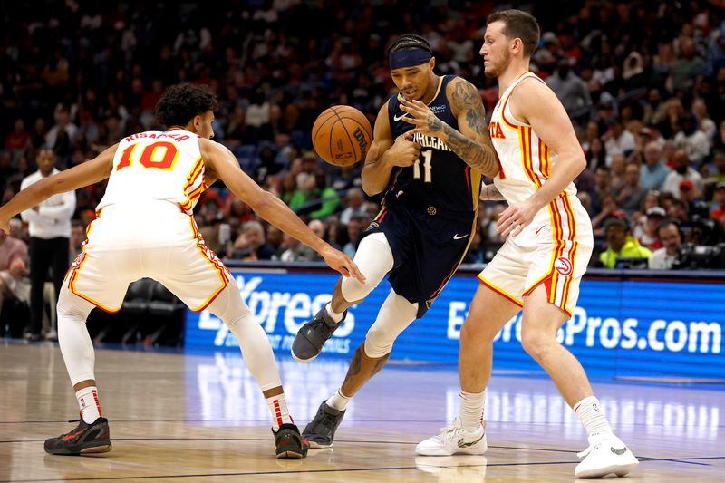 NEW ORLEANS, LOUISIANA - NOVEMBER 03: Brandon Boston Jr. #11 of the New Orleans Pelicans is stripped of the ball by Zaccharie Risacher #10 of the Atlanta Hawks during the fourth quarter of an NBA game at Smoothie King Center on November 03, 2024 in New Orleans, Louisiana. NOTE TO USER: User expressly acknowledges and agrees that, by downloading and or using this photograph, User is consenting to the terms and conditions of the Getty Images License Agreement. (Photo by Sean Gardner/Getty Images)