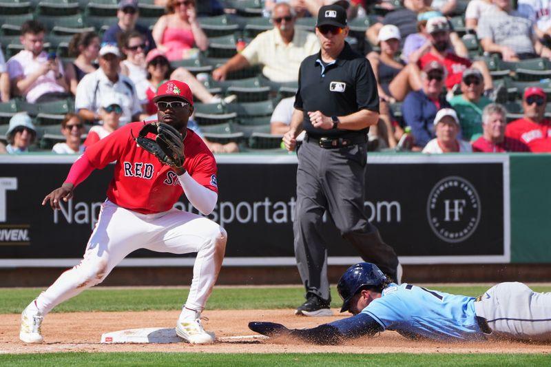 Feb 26, 2026; Fort Myers, Florida, USA; Tampa Bay Rays’ Raynel Delgado (73) steals third base against Boston Red Sox infielder Andruw Monasterio (32) during the fifth inning at JetBlue Park at Fenway South. Mandatory Credit: Jim Rassol-Imagn Images