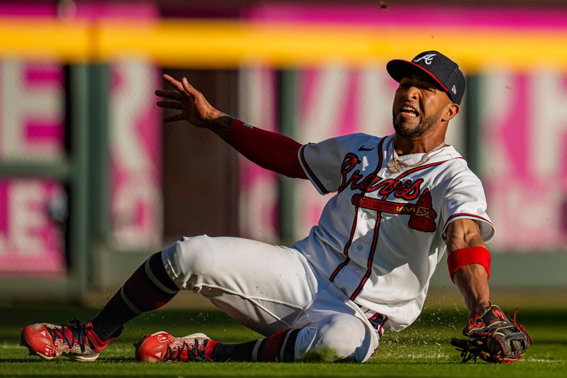 Oct 1, 2023; Cumberland, Georgia, USA; Atlanta Braves left fielder Eddie Rosario (8) makes a sliding catch on a ball hit by Washington Nationals shortstop CJ Abrams (5) (not shown) during the eighth inning at Truist Park. Mandatory Credit: Dale Zanine-USA TODAY Sports