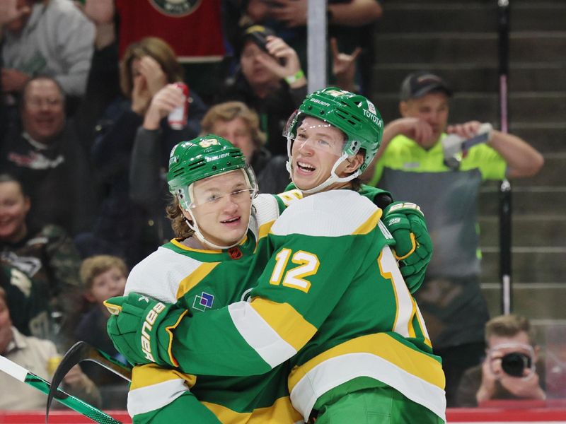 Jan 4, 2023; Saint Paul, Minnesota, USA; Minnesota Wild left wing Kirill Kaprizov (97) celebrates his goal with left wing Matt Boldy (12) during the second period against the Tampa Bay Lightning at Xcel Energy Center. Mandatory Credit: Bruce Fedyck-USA TODAY Sports