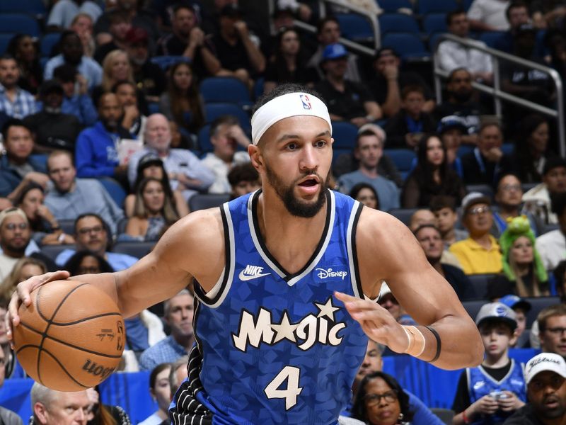 ORLANDO, FL - MARCH 23: Jalen Suggs #4 of the Orlando Magic drives to the basket during the game against the Sacramento Kings on March 23, 2024 at the Kia Center in Orlando, Florida. NOTE TO USER: User expressly acknowledges and agrees that, by downloading and or using this photograph, User is consenting to the terms and conditions of the Getty Images License Agreement. Mandatory Copyright Notice: Copyright 2024 NBAE (Photo by Fernando Medina/NBAE via Getty Images)