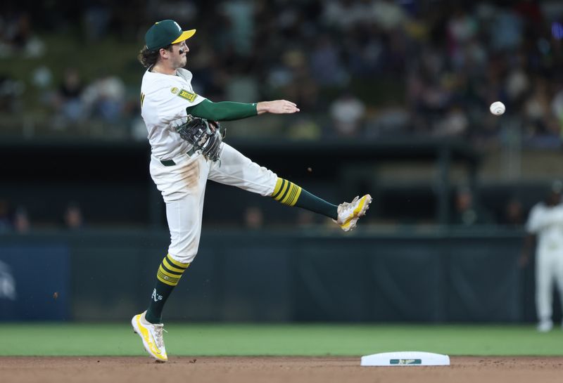 May 5, 2025; West Sacramento, California, USA; Athletics shortstop Jacob Wilson (5) throws to first for an out against the Seattle Mariners during the seventh inning at Sutter Health Park. Mandatory Credit: Dennis Lee-Imagn Images