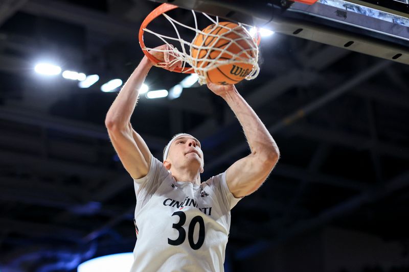 Feb 4, 2023; Cincinnati, Ohio, USA;  Cincinnati Bearcats forward Viktor Lakhin (30) dunks the ball against the UCF Knights in the first half at Fifth Third Arena. Mandatory Credit: Aaron Doster-USA TODAY Sports