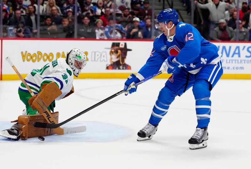 Oct 23, 2025; Denver, Colorado, USA; Carolina Hurricanes goaltender Frederik Andersen (31) makes a save on Colorado Avalanche defenseman Josh Manson (42) in the second period at Ball Arena. Mandatory Credit: Ron Chenoy-Imagn Images