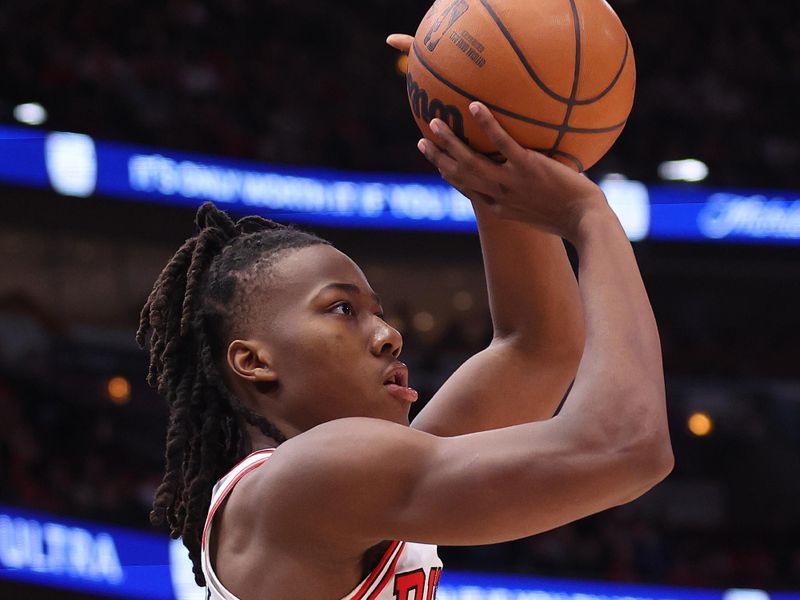 CHICAGO, ILLINOIS - FEBRUARY 26: Ayo Dosunmu #12 of the Chicago Bulls shoots a three pointer against the Washington Wizards during the second half at United Center on February 26, 2023 in Chicago, Illinois. NOTE TO USER: User expressly acknowledges and agrees that, by downloading and or using this photograph, User is consenting to the terms and conditions of the Getty Images License Agreement.  (Photo by Michael Reaves/Getty Images)