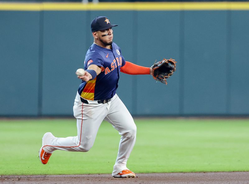 Jun 1, 2025; Houston, Texas, USA; Houston Astros third baseman Isaac Paredes (15) throws out Tampa Bay Rays designated hitter Yandy Diaz (2) (not pictured) at first base  in the first inning at Daikin Park. Mandatory Credit: Thomas Shea-Imagn Images