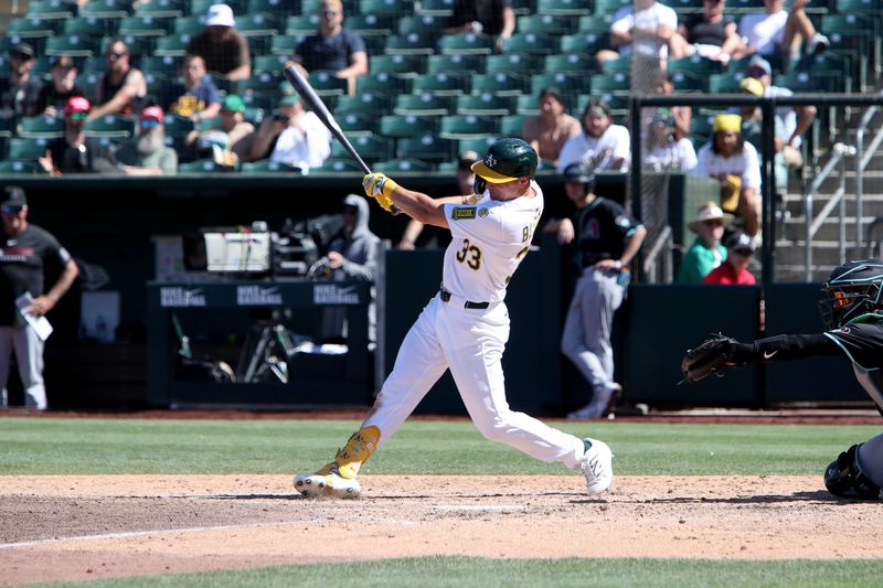 Aug 3, 2025; West Sacramento, California, USA; Athletics left fielder JJ Bleday (33) hits a solo home run against the Arizona Diamondbacks during the ninth inning at Sutter Health Park. Mandatory Credit: Dennis Lee-Imagn Images