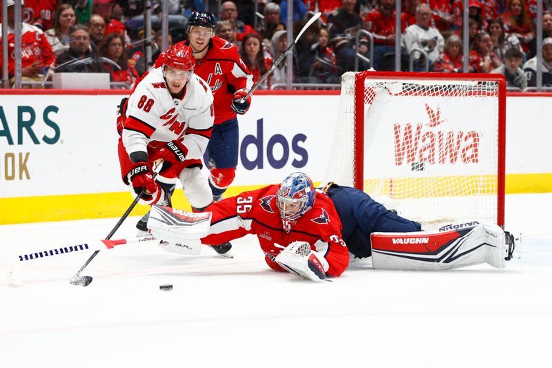 Mar 22, 2024; Washington, District of Columbia, USA; Washington Capitals goaltender Darcy Kuemper (35) reaches for the puck in front of Carolina Hurricanes center Martin Necas (88) during the second period at Capital One Arena. Mandatory Credit: Amber Searls-USA TODAY Sports