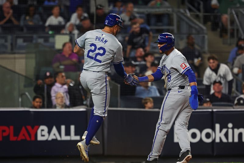 Oct 5, 2024; Bronx, New York, USA; Kansas City Royals first base Yuli Gurriel (18) and Kansas City Royals outfielder Tommy Pham (22) celebrate after a play against New York Yankees during the second inning during game one of the ALDS for the 2024 MLB Playoffs at Yankee Stadium. Mandatory Credit: Vincent Carchietta-Imagn Images