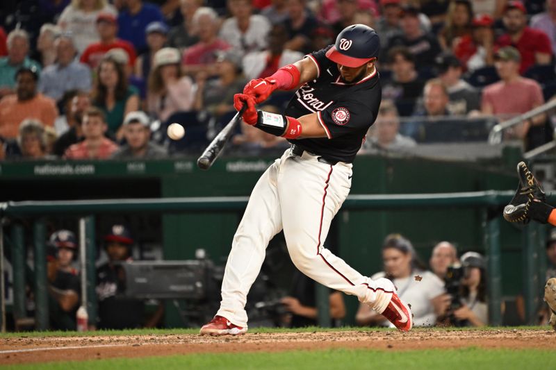 Jul 2, 2024; Washington, District of Columbia, USA; Washington Nationals catcher Keibert Ruiz (20) hits the ball into play against the New York Mets during the ninth inning at Nationals Park. Mandatory Credit: Rafael Suanes-USA TODAY Sports