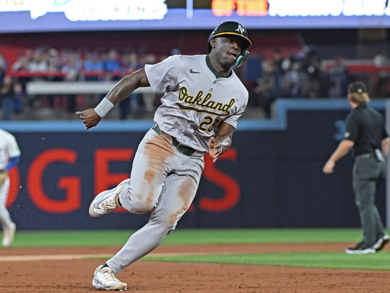 Aug 11, 2024; Toronto, Ontario, CAN; Oakland Athletics left field Cameron Daz at Rogers (28) rounds third base on a RBI single by right field Lawrence Butler (4) in the first inning against the Toronto Blue Jays Centre. Mandatory Credit: Gerry Angus-USA TODAY Sports