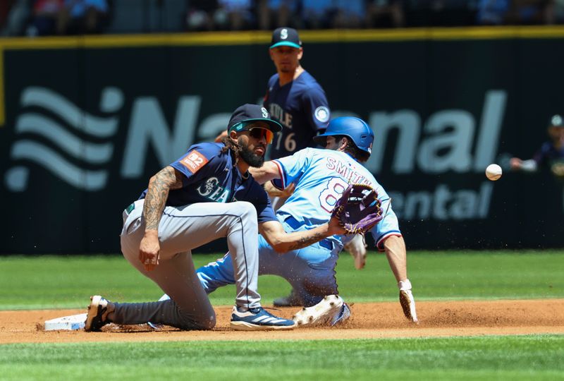May 4, 2025; Arlington, Texas, USA;  Texas Rangers center fielder Josh Smith (8) slides safely into second base ahead of the tag by Seattle Mariners shortstop J.P. Crawford (3) during the first inning at Globe Life Field. Mandatory Credit: Kevin Jairaj-Imagn Images