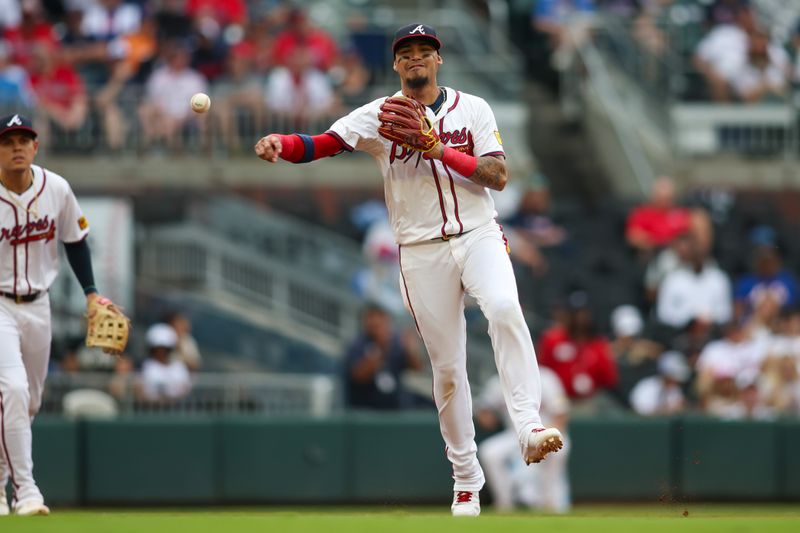 Sep 30, 2024; Atlanta, Georgia, USA; Atlanta Braves shortstop Orlando Arcia (11) throws a runner out at first against the New York Mets in the sixth inning at Truist Park. Mandatory Credit: Brett Davis-Imagn Images
