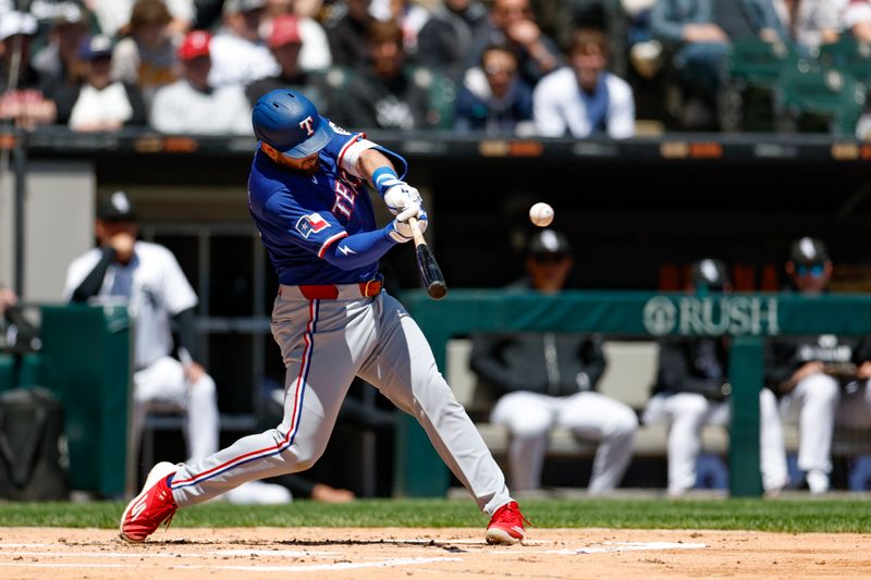 May 25, 2025; Chicago, Illinois, USA; Texas Rangers first baseman Jake Burger (21) hits a two-run home run against the Chicago White Sox during the second inning at Rate Field. Mandatory Credit: Kamil Krzaczynski-Imagn Images
