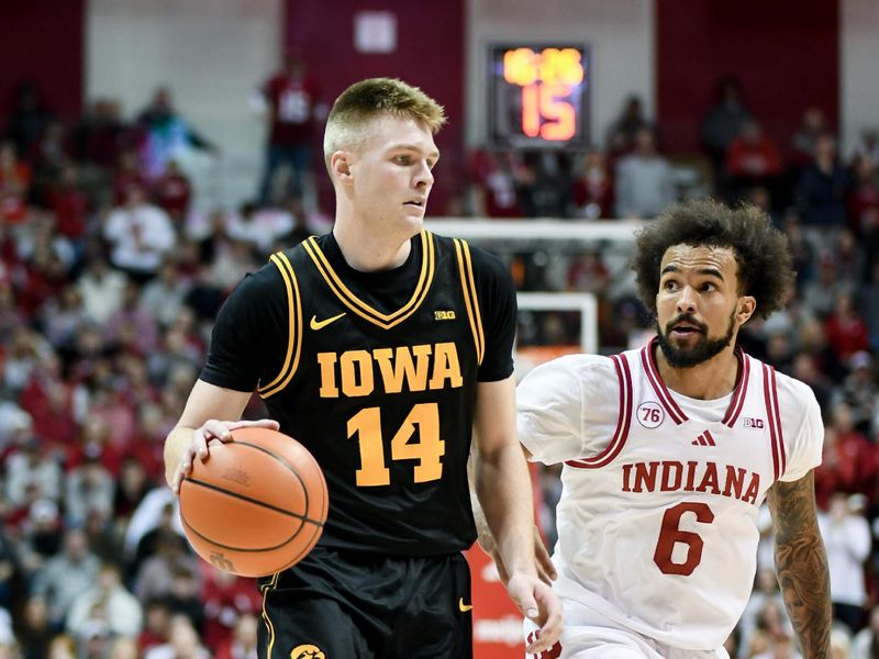 Jan 17, 2026; Bloomington, Indiana, USA; Iowa Hawkeyes guard Bennett Stirtz (14) dribbles the ball against Indiana Hoosiers guard Tayton Conerway (6) during the second half at Simon Skjodt Assembly Hall. Mandatory Credit: Robert Goddin-Imagn Images