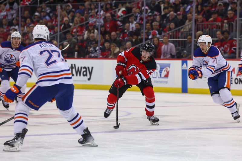 Dec 21, 2023; Newark, New Jersey, USA; New Jersey Devils defenseman Luke Hughes (43) skates with the puck against the Edmonton Oilers during the second period at Prudential Center. Mandatory Credit: Ed Mulholland-USA TODAY Sports