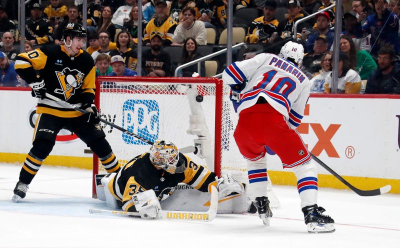 Mar 16, 2024; Pittsburgh, Pennsylvania, USA;  New York Rangers left wing Artemi Panarin (10) scores his second goal of the game against Pittsburgh Penguins goaltender Tristan Jarry (35) during the second period at PPG Paints Arena. Mandatory Credit: Charles LeClaire-USA TODAY Sports