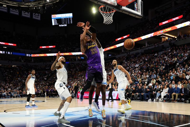 MINNEAPOLIS, MINNESOTA - DECEMBER 02: Rui Hachimura #28 of the Los Angeles Lakers is fouled by Naz Reid #11 of the Minnesota Timberwolves in the third quarter at Target Center on December 02, 2024 in Minneapolis, Minnesota. The Timberwolves defeated the Lakers 109-80. NOTE TO USER: User expressly acknowledges and agrees that, by downloading and or using this photograph, User is consenting to the terms and conditions of the Getty Images License Agreement. (Photo by David Berding/Getty Images)