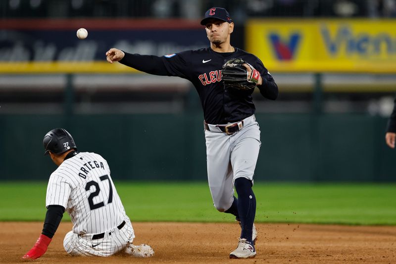 May 9, 2024; Chicago, Illinois, USA; Cleveland Guardians second baseman Andres Gimenez (0) throws out at second base Chicago White Sox outfielder Rafael Ortega (27) during the seventh inning at Guaranteed Rate Field. Mandatory Credit: Kamil Krzaczynski-USA TODAY Sports