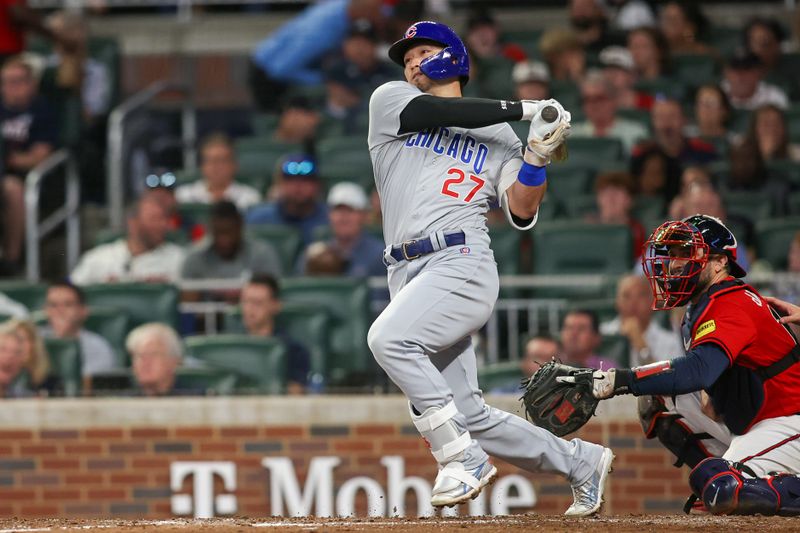 Sep 28, 2023; Atlanta, Georgia, USA; Chicago Cubs right fielder Seiya Suzuki (27) hits a RBI double against the Atlanta Braves in the sixth inning at Truist Park. Mandatory Credit: Brett Davis-USA TODAY Sports