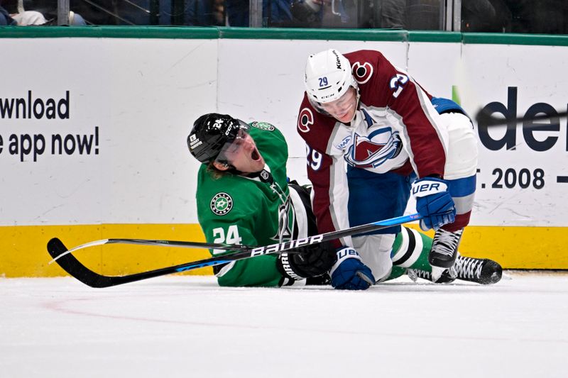 Mar 6, 2026; Dallas, Texas, USA; Dallas Stars center Roope Hintz (24) appears to suffer a lower body injury as he is engages with Colorado Avalanche center Nathan MacKinnon (29) along the boards during the second period at the American Airlines Center. Mandatory Credit: Jerome Miron-Imagn Images