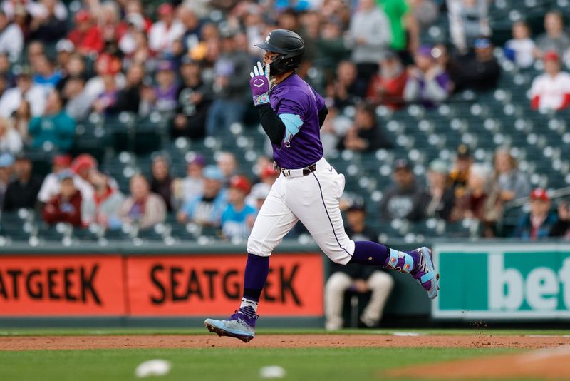 May 19, 2025; Denver, Colorado, USA; Colorado Rockies shortstop Ezequiel Tovar (14) rounds the bases on a solo home run in the first inning against the Philadelphia Phillies at Coors Field. Mandatory Credit: Isaiah J. Downing-Imagn Images