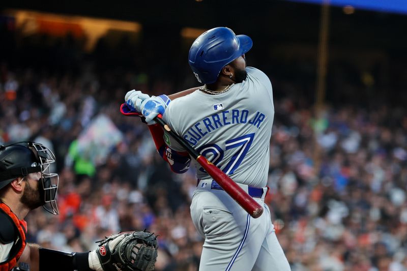 Jul 10, 2024; San Francisco, California, USA; Toronto Blue Jays first base Vladimir Guerrero Jr. (27) hits a double during the sixth inning against the San Francisco Giants at Oracle Park. Mandatory Credit: Sergio Estrada-USA TODAY Sports