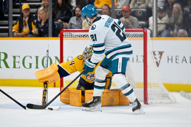 Mar 24, 2026; Nashville, Tennessee, USA;  Nashville Predators goaltender Juuse Saros (74) blocks the shot of of San Jose Sharks center Alexander Wennberg (21) during the second period at Bridgestone Arena. Mandatory Credit: Steve Roberts-Imagn Images
