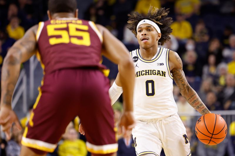 Jan 22, 2023; Ann Arbor, Michigan, USA;  Michigan Wolverines guard Dug McDaniel (0) dribbles defended by Minnesota Golden Gophers guard Ta'lon Cooper (55) in the first half at Crisler Center. Mandatory Credit: Rick Osentoski-USA TODAY Sports