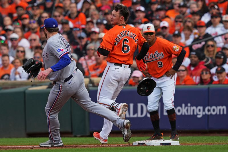 Oct 8, 2023; Baltimore, Maryland, USA; Baltimore Orioles first baseman Ryan Mountcastle (6) reaches first base ahead of the force out of Texas Rangers starting pitcher Jordan Montgomery (52) during the first inning during game two of the ALDS for the 2023 MLB playoffs at Oriole Park at Camden Yards. Mandatory Credit: Mitch Stringer-USA TODAY Sports
