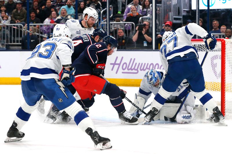 Nov 21, 2024; Columbus, Ohio, USA; Tampa Bay Lightning goalie Jonas Johansson (31) makes a save as Columbus Blue Jackets defenseman Jake Christiansen (2) looks for a rebound during the second period at Nationwide Arena. Mandatory Credit: Russell LaBounty-Imagn Images