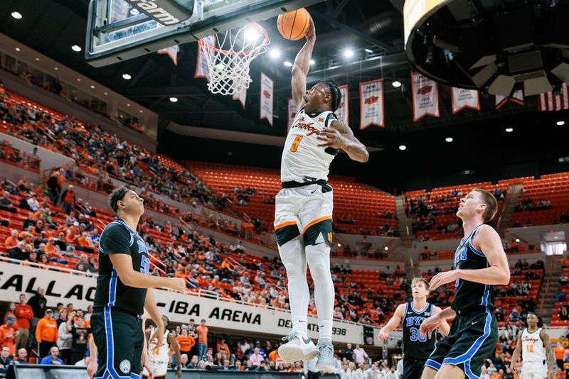 Feb 17, 2024; Stillwater, Oklahoma, USA; Oklahoma State Cowboys guard Quion Williams (5) dunks the ball during the first half against the Brigham Young Cougars at Gallagher-Iba Arena. Mandatory Credit: William Purnell-USA TODAY Sports