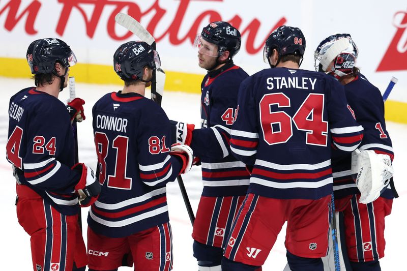Oct 24, 2025; Winnipeg, Manitoba, CAN; Winnipeg Jets celebrate their victory against the Calgary Flames at Canada Life Centre. Mandatory Credit: James Carey Lauder-Imagn Images