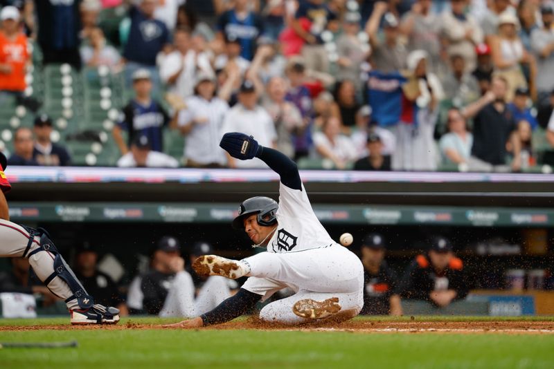 Sep 21, 2025; Detroit, Michigan, USA;  Detroit Tigers outfielder Jahmai Jones (18) slides into safe at home in the ninth inning against the Atlanta Braves at Comerica Park. Mandatory Credit: Rick Osentoski-Imagn Images