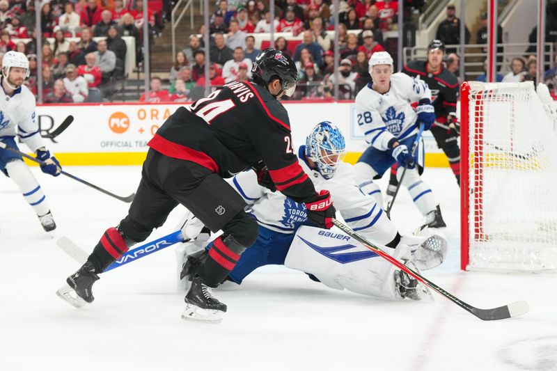 Dec 4, 2025; Raleigh, North Carolina, USA; Carolina Hurricanes center Seth Jarvis (24) tries to get the shot past Toronto Maple Leafs goaltender Joseph Woll (60) during the first period at Lenovo Center. Mandatory Credit: James Guillory-Imagn Images Dec 4, 2025; Raleigh, North Carolina, USA; Carolina Hurricanes center Seth Jarvis (24) tries to get the shot past Toronto Maple Leafs goaltender Joseph Woll (60) during the first period at Lenovo Center. Mandatory Credit: James Guillory-Imagn Images