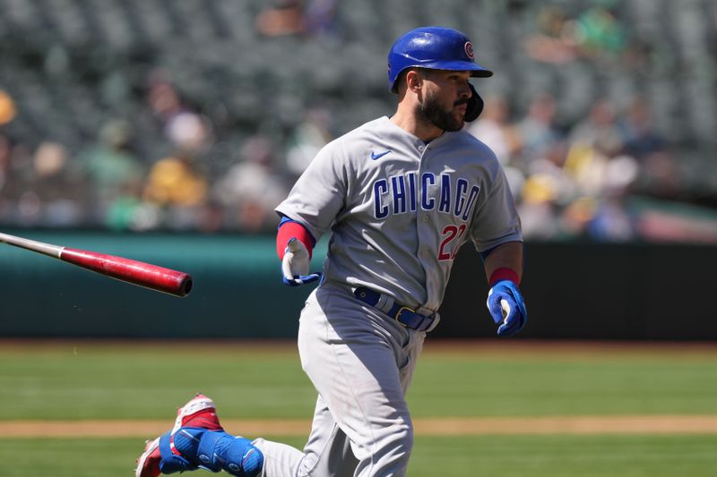 Apr 19, 2023; Oakland, California, USA; Chicago Cubs catcher Luis Torrens (22) tosses his bat while running to first base after hitting an RBI-double against the Oakland Athletics during the ninth inning at Oakland-Alameda County Coliseum. Mandatory Credit: Darren Yamashita-USA TODAY Sports