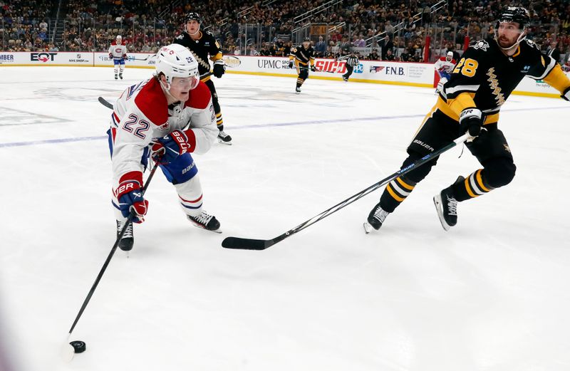 Feb 22, 2024; Pittsburgh, Pennsylvania, USA; Montreal Canadiens right wing Cole Caufield (22) skates with the puck against Pittsburgh Penguins defenseman Marcus Pettersson (28) during the second period at PPG Paints Arena. Mandatory Credit: Charles LeClaire-USA TODAY Sports