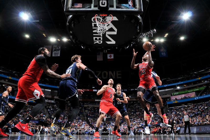 ORLANDO, FL - APRIL 7: Ayo Dosunmu #12 of the Chicago Bulls drives to the basket during the game against the Orlando Magic on April 7, 2024 at the Kia Center in Orlando, Florida. NOTE TO USER: User expressly acknowledges and agrees that, by downloading and or using this photograph, User is consenting to the terms and conditions of the Getty Images License Agreement. Mandatory Copyright Notice: Copyright 2024 NBAE (Photo by Fernando Medina/NBAE via Getty Images)