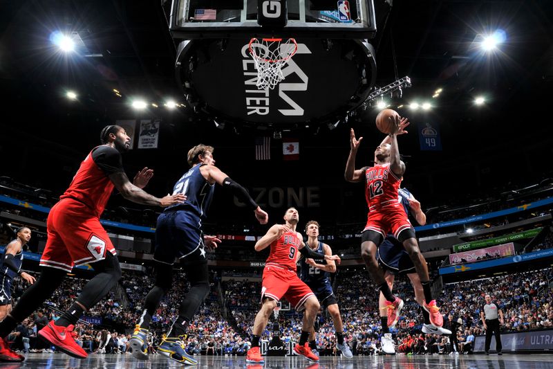 ORLANDO, FL - APRIL 7: Ayo Dosunmu #12 of the Chicago Bulls drives to the basket during the game against the Orlando Magic on April 7, 2024 at the Kia Center in Orlando, Florida. NOTE TO USER: User expressly acknowledges and agrees that, by downloading and or using this photograph, User is consenting to the terms and conditions of the Getty Images License Agreement. Mandatory Copyright Notice: Copyright 2024 NBAE (Photo by Fernando Medina/NBAE via Getty Images)