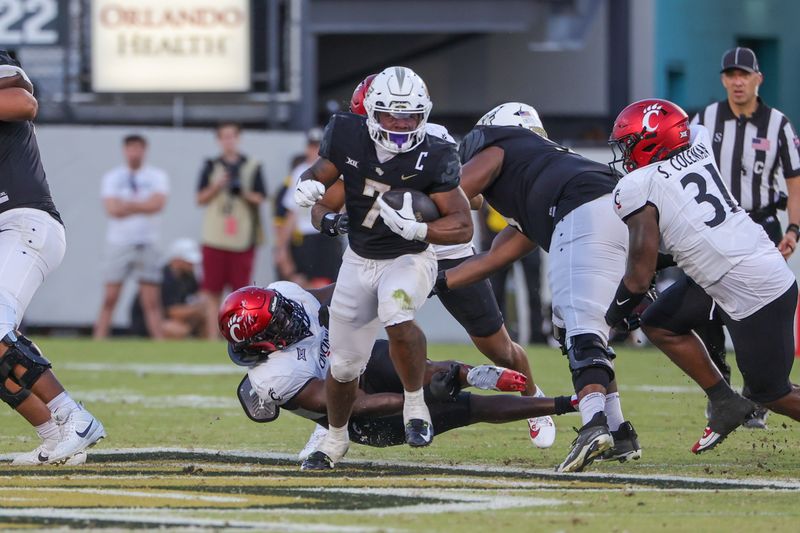 Oct 12, 2024; Orlando, Florida, USA; UCF Knights running back RJ Harvey (7) carries the ball during the second half against the Cincinnati Bearcats at FBC Mortgage Stadium. Mandatory Credit: Mike Watters-Imagn Images