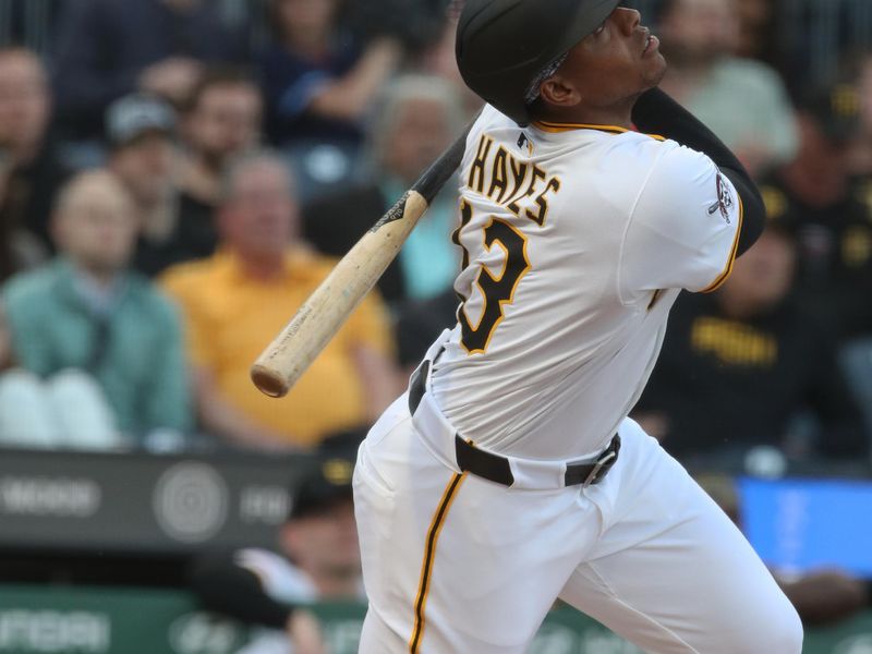 Apr 30, 2025; Pittsburgh, Pennsylvania, USA;  Pittsburgh Pirates third baseman Ke'Bryan Hayes (13) hits an RBI single against the Chicago Cubs during the first inning at PNC Park. Mandatory Credit: Charles LeClaire-Imagn Images