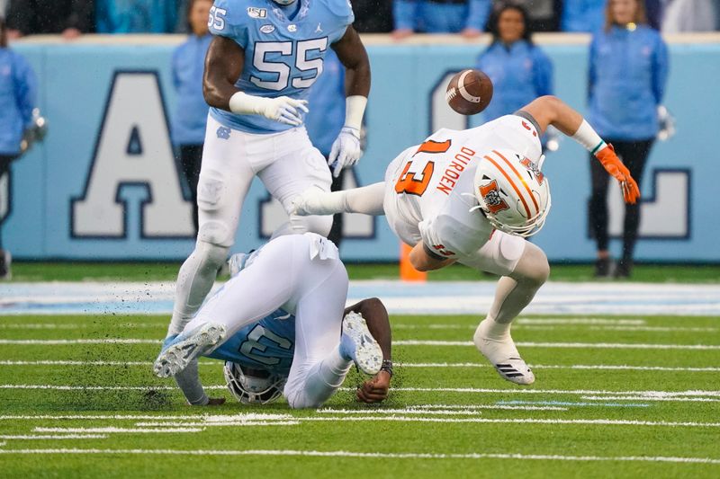 Nov 23, 2019; Chapel Hill, NC, USA; North Carolina Tar Heels linebacker Dominique Ross (3) hits Mercer Bears wide receiver David Durden (13) causes a fumble during the first half at Kenan Memorial Stadium. Mandatory Credit: James Guillory-USA TODAY Sports