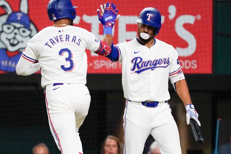 Jul 22, 2024; Arlington, Texas, USA; Texas Rangers center fielder Leody Taveras (3) high fives second baseman Marcus Semien (2) after hitting a solo home run during the fifth inning against the Chicago White Sox at Globe Life Field. Mandatory Credit: Raymond Carlin III-USA TODAY Sports