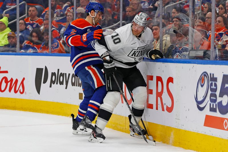 Jan 10, 2026; Edmonton, Alberta, CAN; Los Angeles Kings forward Corey Perry (10) and Edmonton Oilers defensemen Evan Bouchard (2) battle along the boards for a loose puck  during the second period at Rogers Place. Mandatory Credit: Perry Nelson-Imagn Images