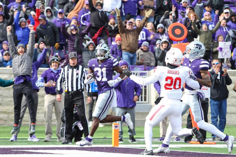 Oct 28, 2023; Manhattan, Kansas, USA; Kansas State Wildcats running back DJ Giddens (31) scores a touchdown in the fourth quarter against the Houston Cougars at Bill Snyder Family Football Stadium. Mandatory Credit: Scott Sewell-USA TODAY Sports